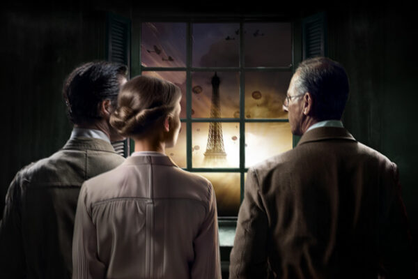 Two men and one woman look ahead with the Eifflel tower visible through the window in front of them